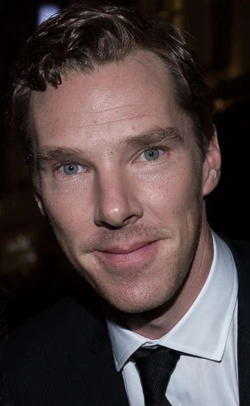 a man in a suit and tie smiling for a picture