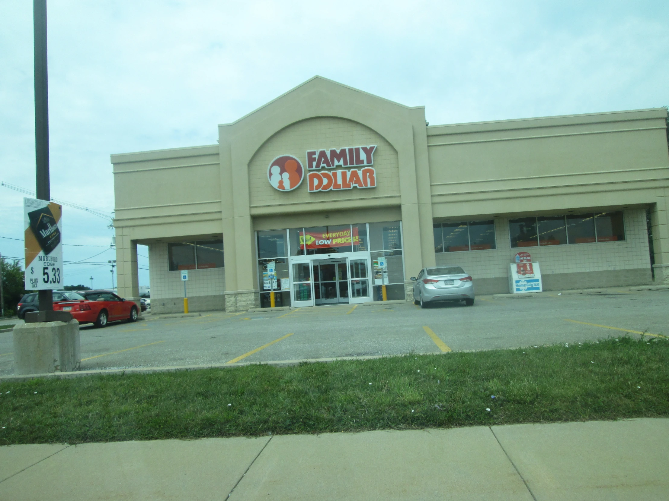 a large family dollar store sits on the corner of a parking lot