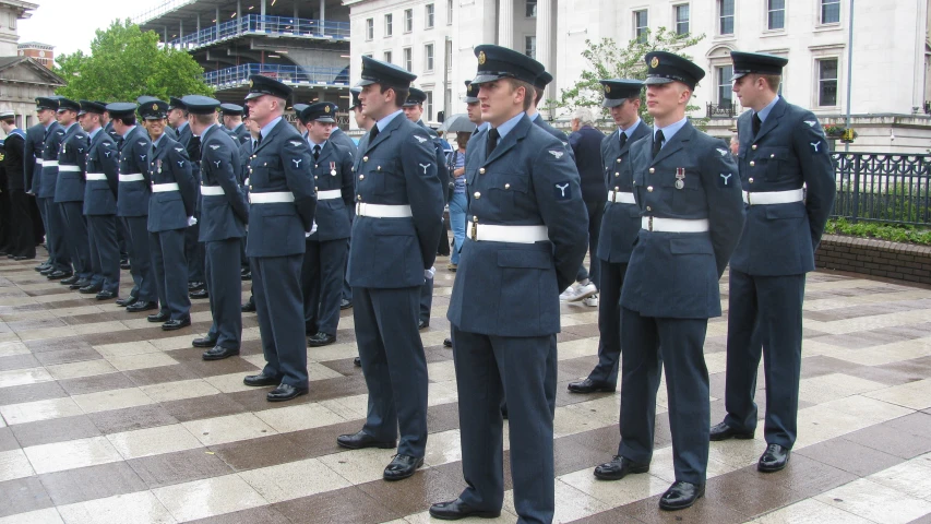 a group of uniformed men stand in a row