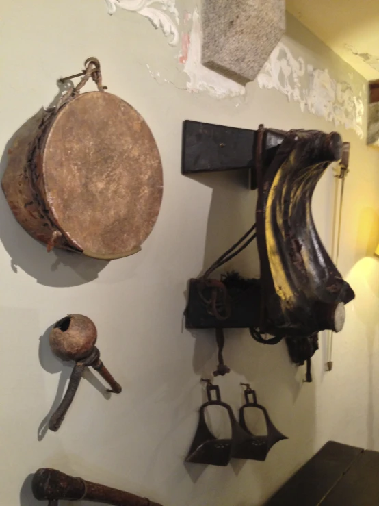 two wooden bells hang from a white wall