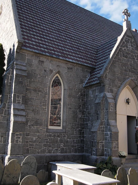 a church with three stone benches in front of it