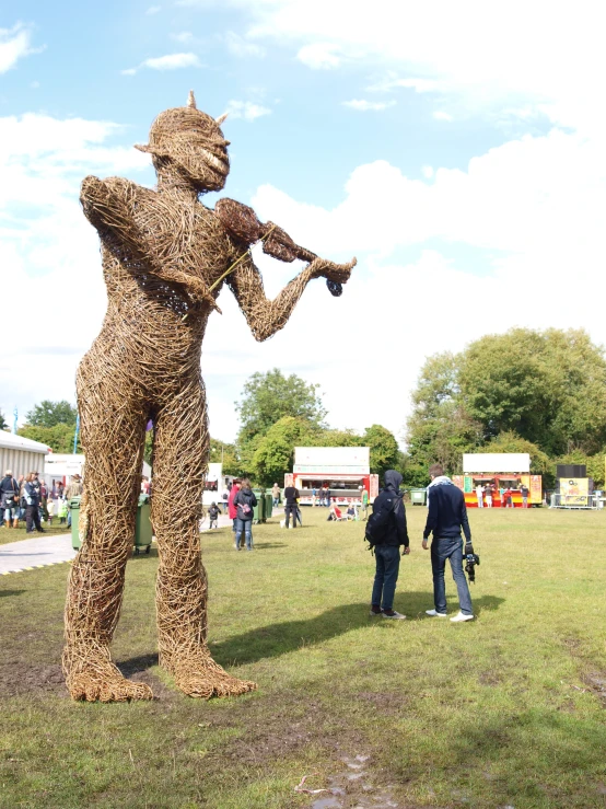 people in a field are looking at items made from yarn