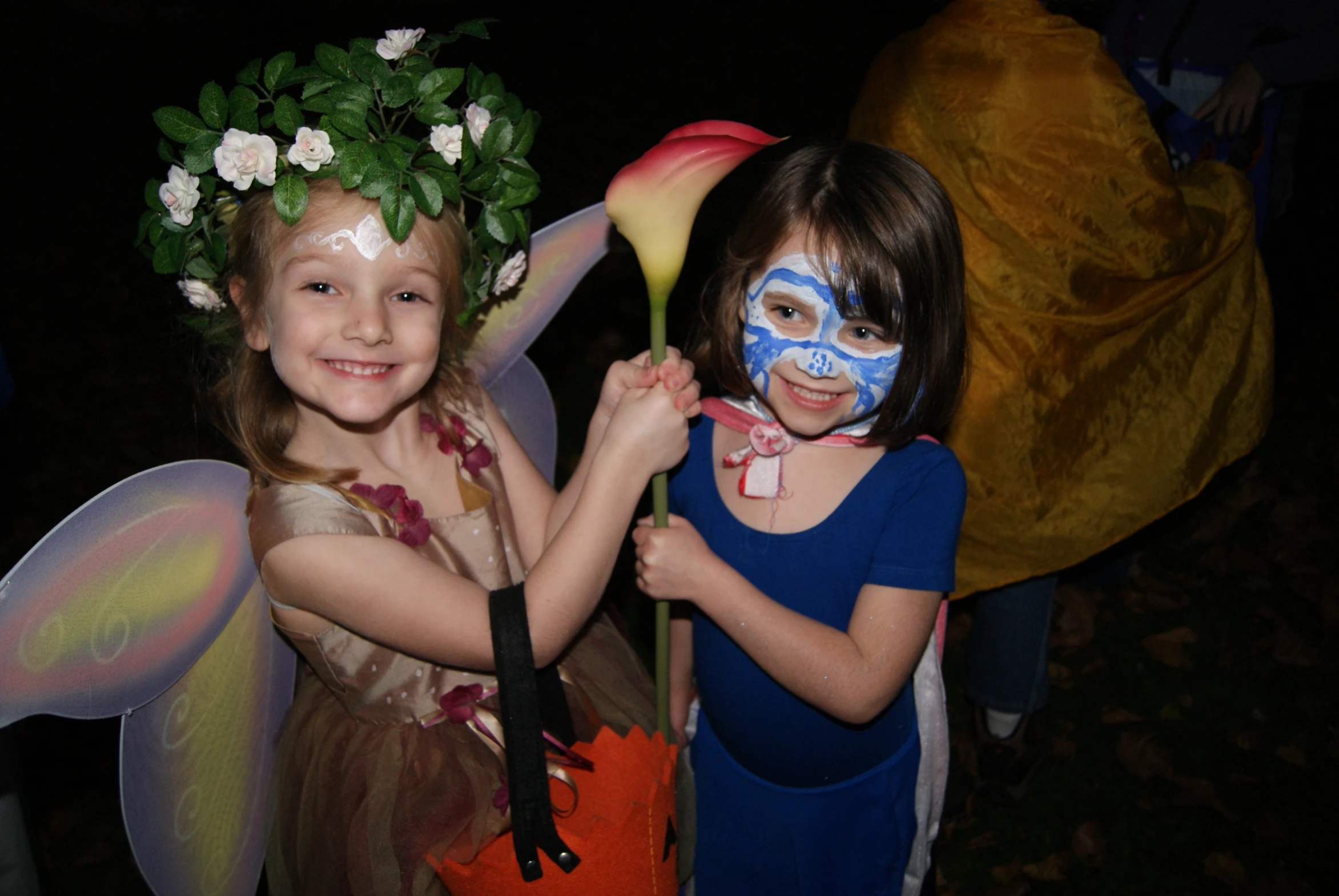 two s with body paint holding flowers