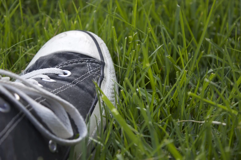 the person has their shoes in the grass