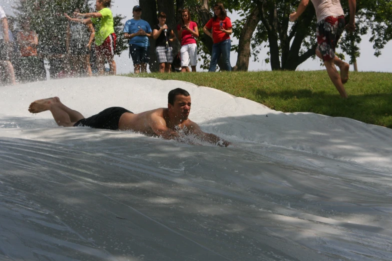 a man sliding down a slides at a water park