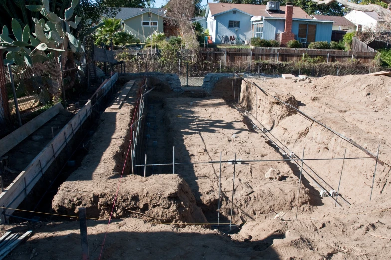 an unfinished building sits on a large lot of dirt