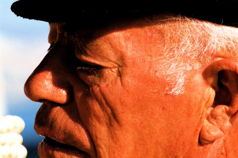 closeup of an old man wearing a hat