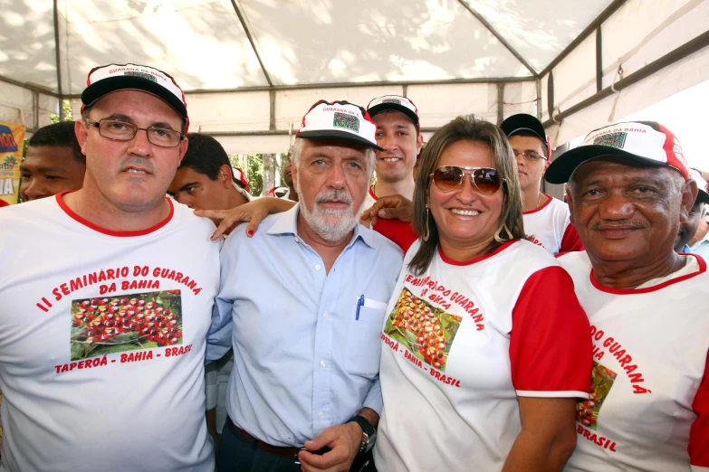 group of people with matching shirts and hats posing in line