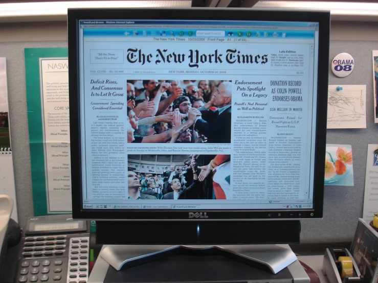 there is a computer monitor that has some new york times on it