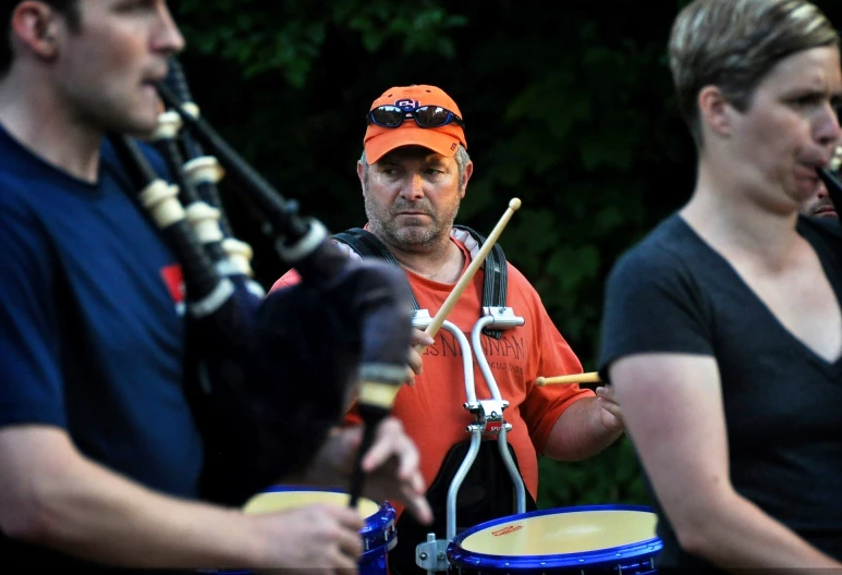 there are three people that are playing musical instruments