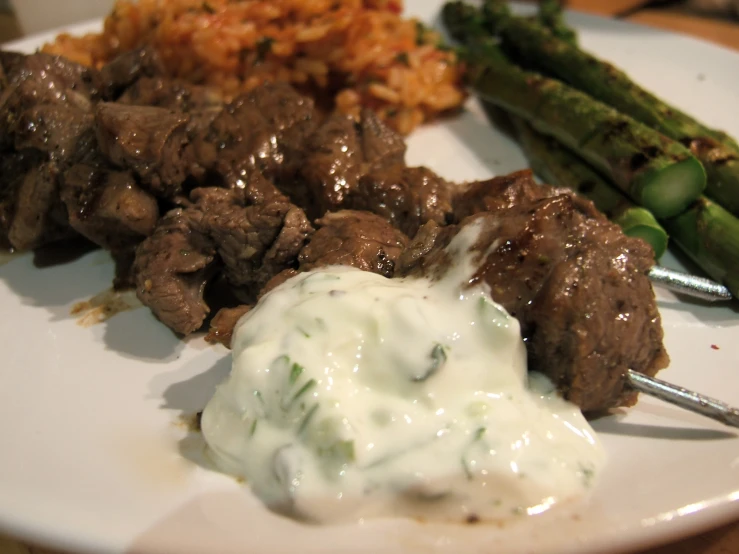 a plate that has been served and has some meat on it