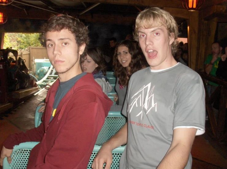 two young men are standing near each other