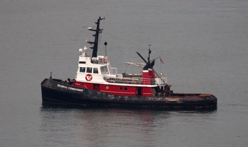 the red and white boat is traveling in the ocean