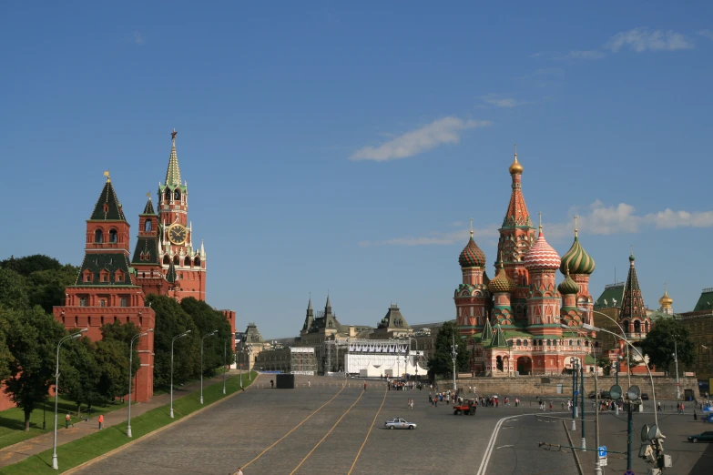 a city street has three large buildings with domes