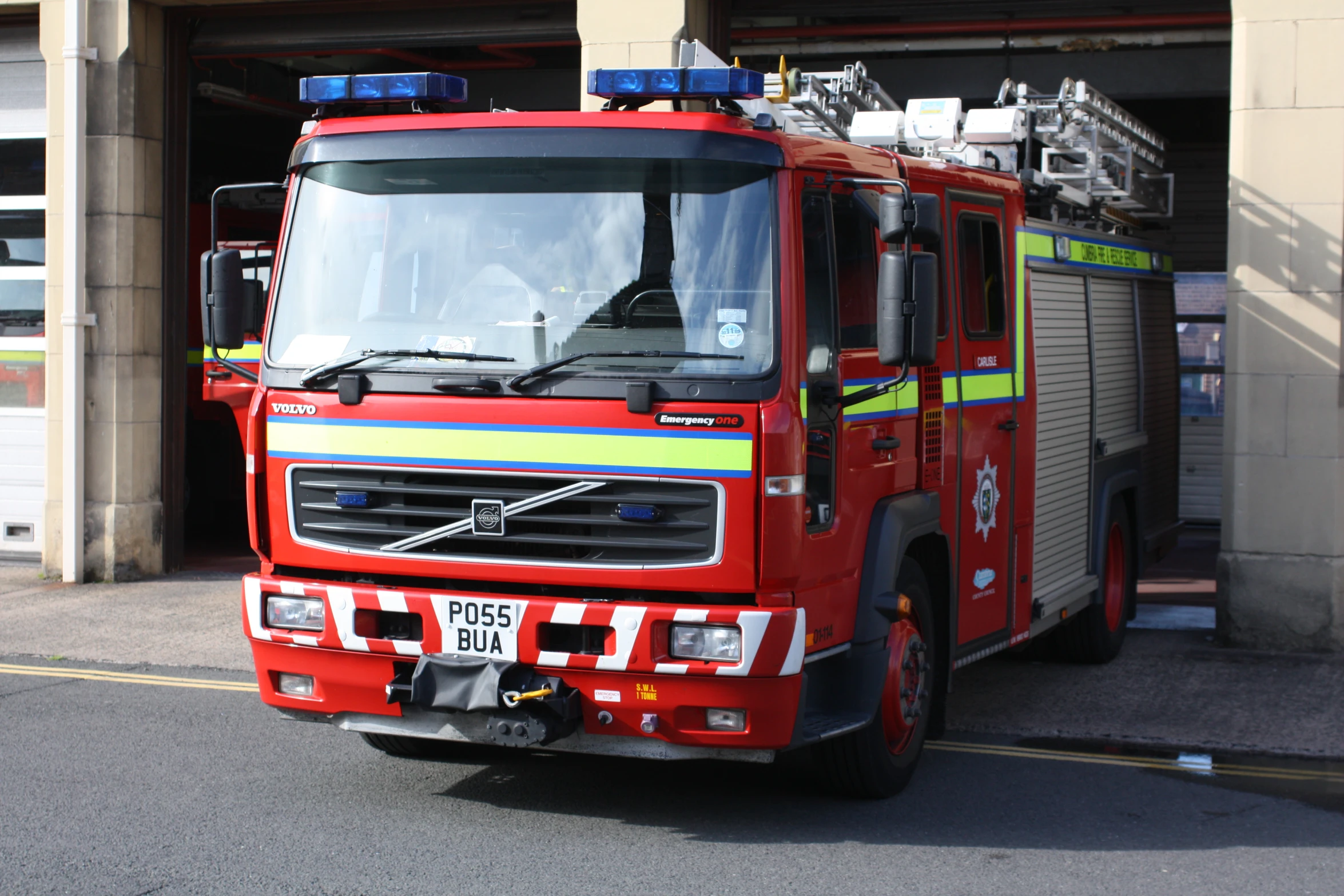 a red fire engine parked next to another fire truck