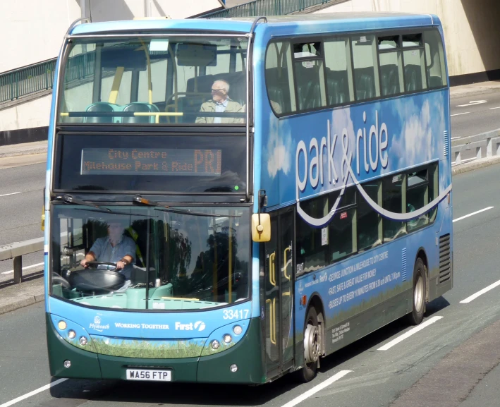 a double decker bus driving down the road