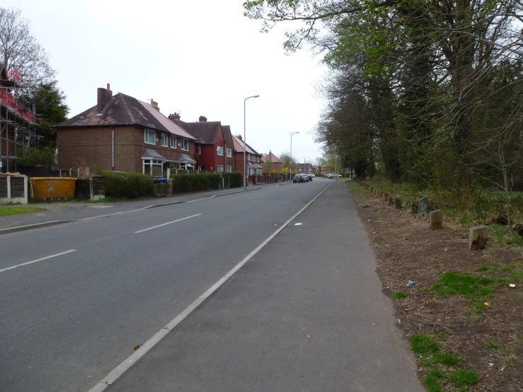 a long street lined with brick houses and trees