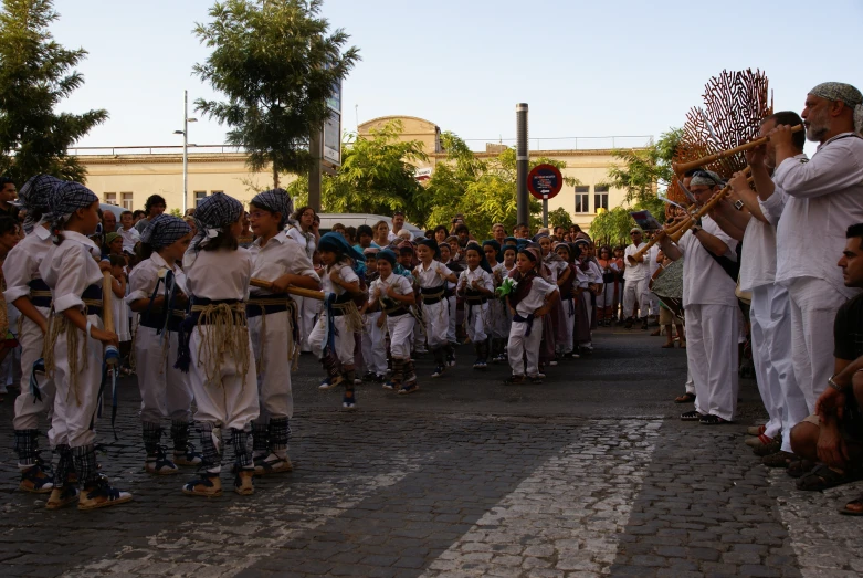 people standing in line on the street at an outdoor event