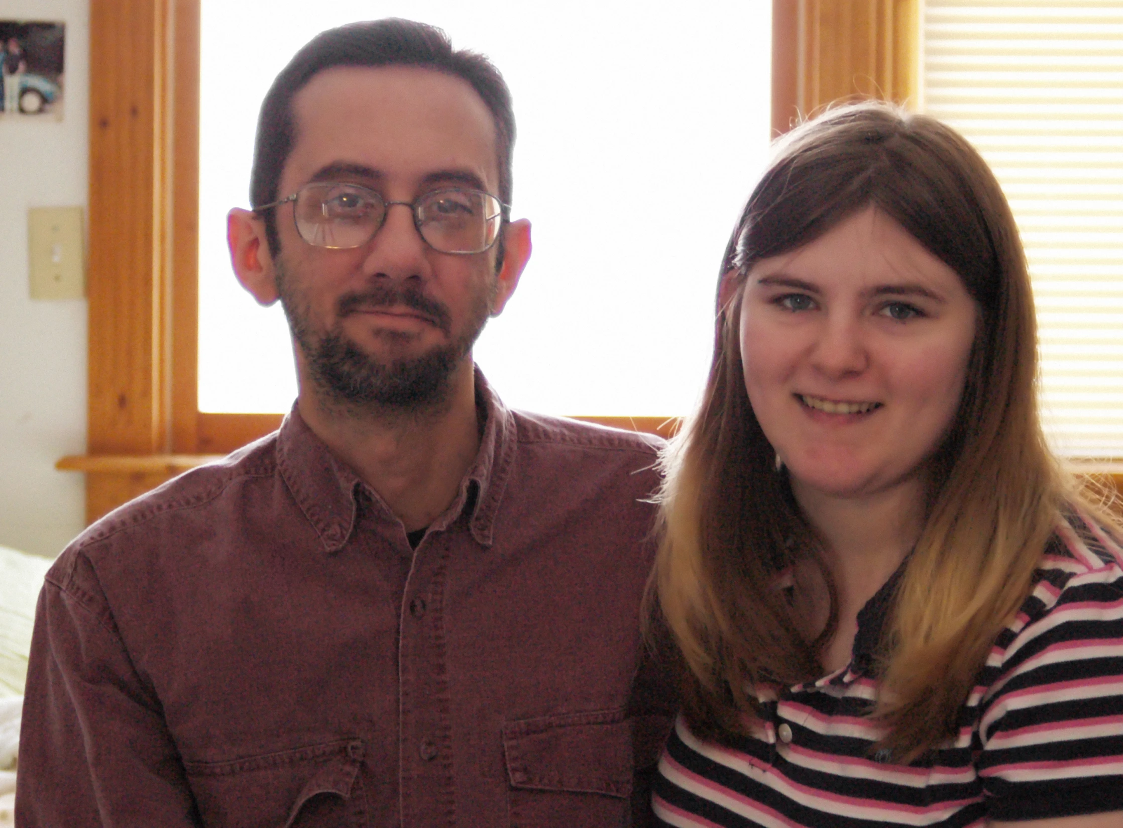 a man and woman posing for the camera