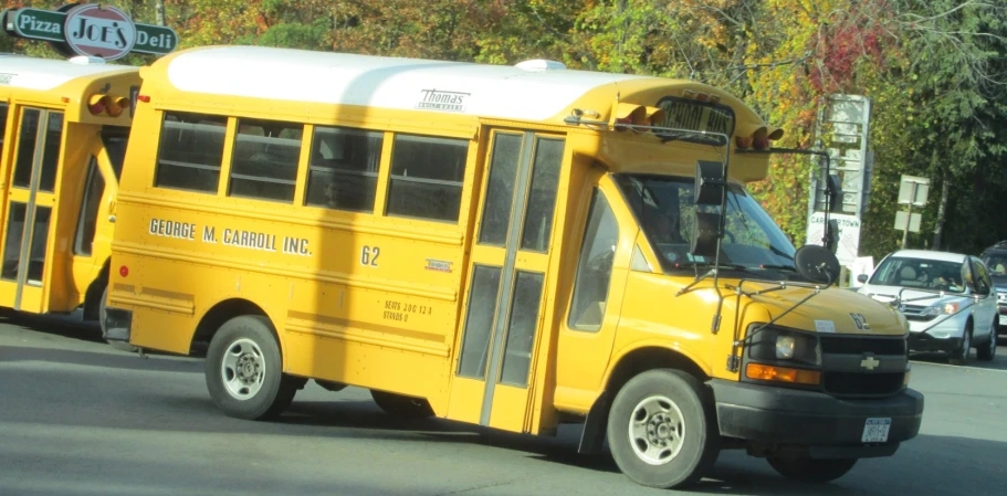 two yellow school buses parked side by side on a street