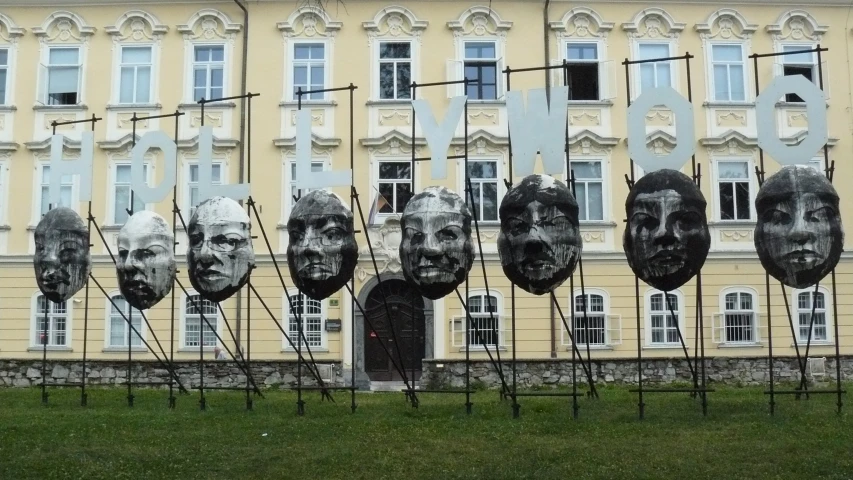 several sculptures with faces attached to each other
