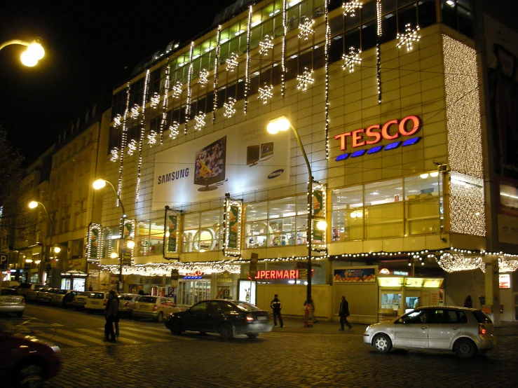 the illuminated building of a shopping mall at night