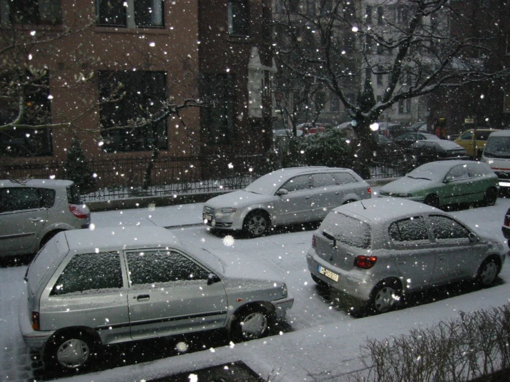 the cars are driving in the snow storm