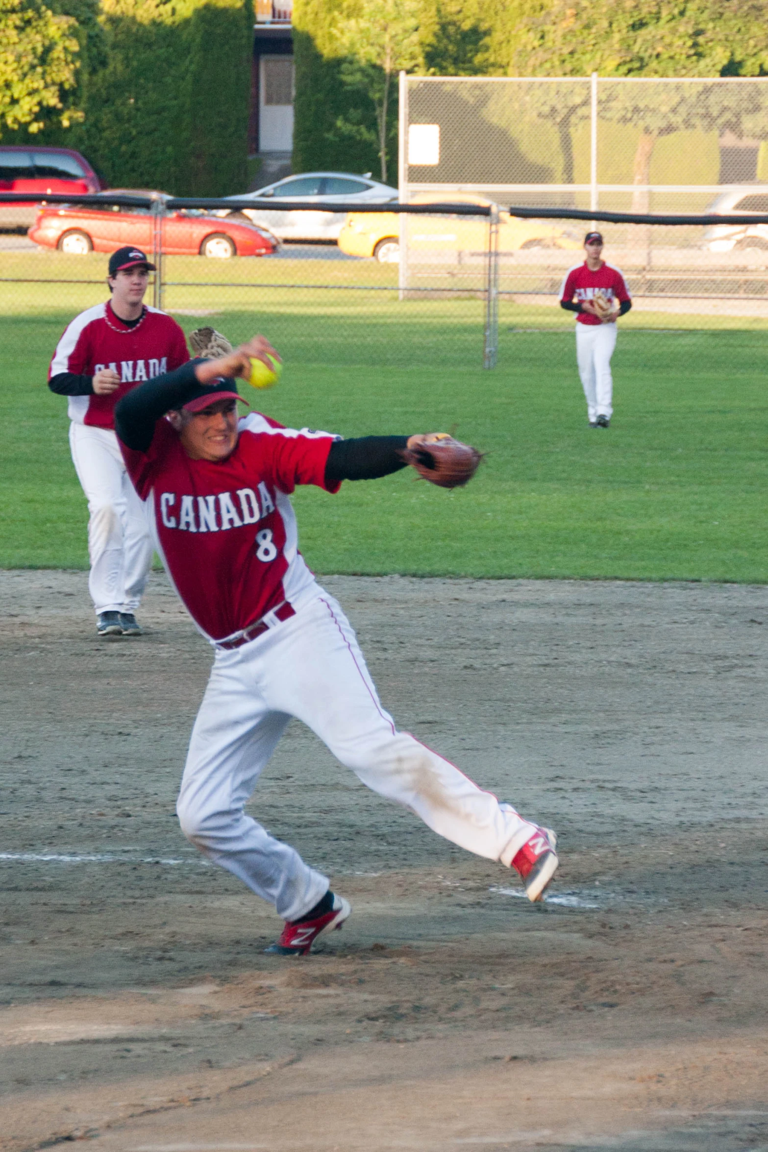 a baseball player throwing a ball in a game