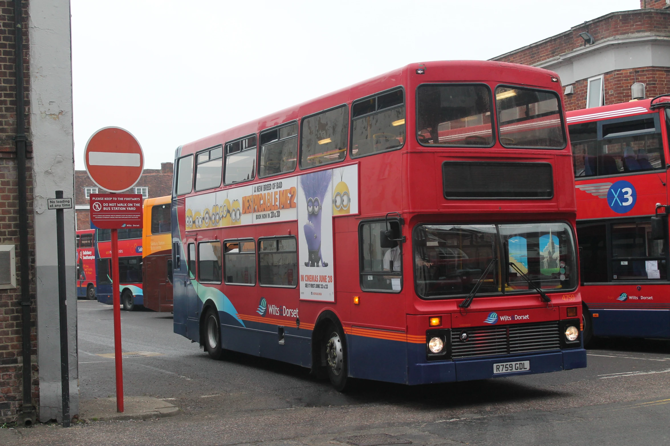 two double decker buses are stopped on a street