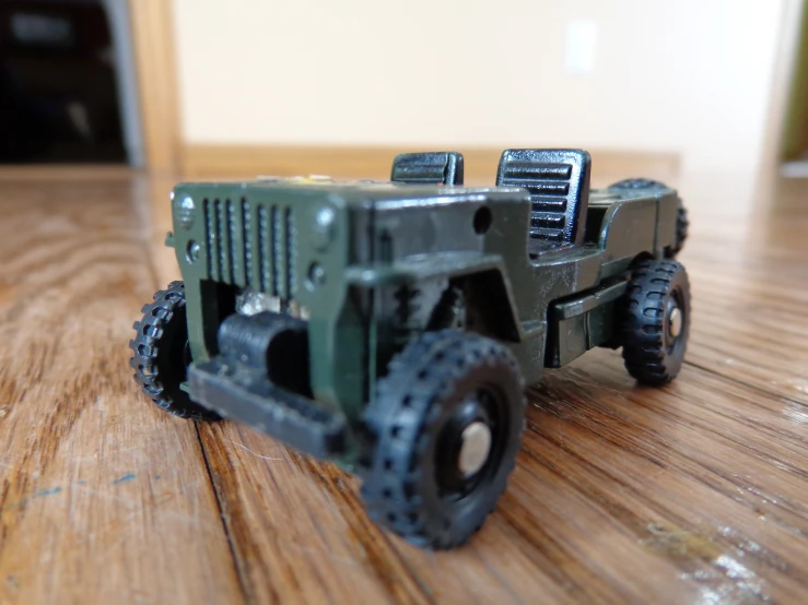 a close up of a toy truck on a wooden table