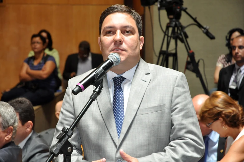 a man in a suit and tie giving a speech