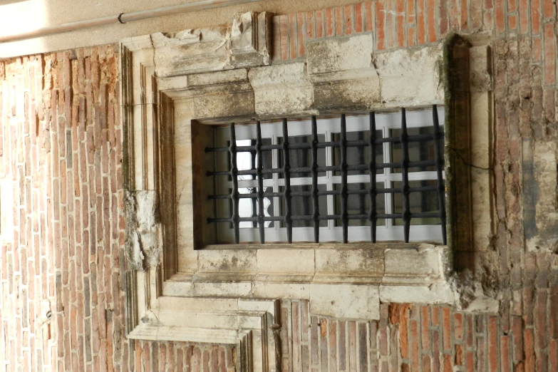 a window frame with iron bars hanging on it
