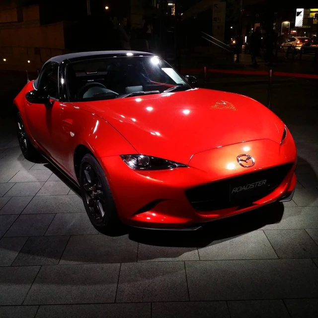 a mazda sports car is lit up for the night