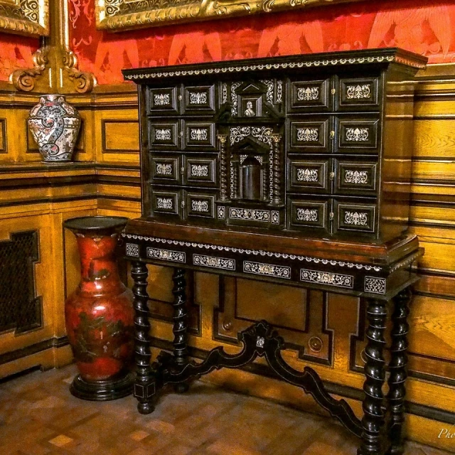 a very old looking wooden cabinet with an ornate top