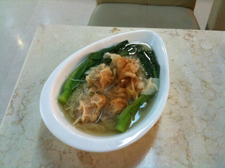 food sitting on a counter in a white bowl