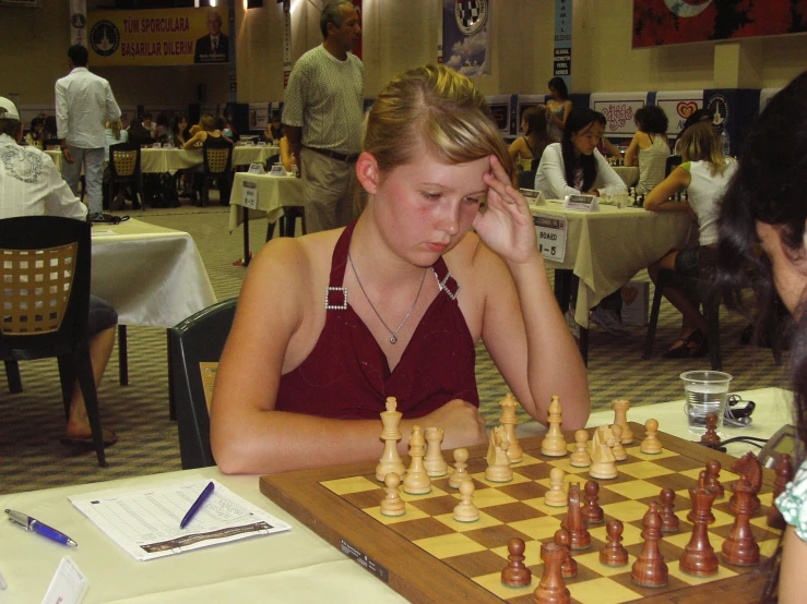 a chess game is playing in the middle of a cafe