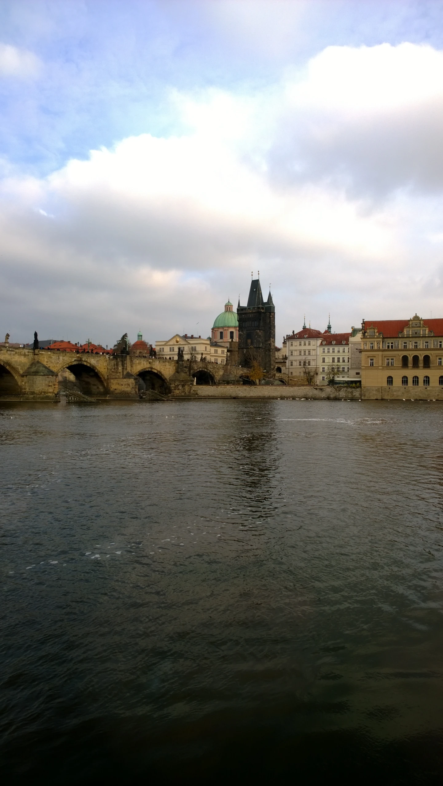 a river view with several buildings in the background