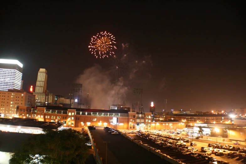 fireworks explode in the sky over a city at night