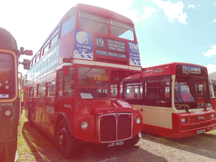 a double decker bus and a double decker bus parked in a parking lot