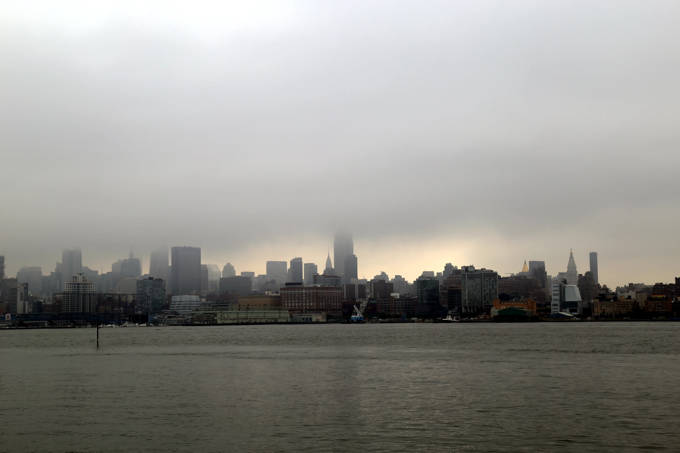 a skyline of large buildings with water below