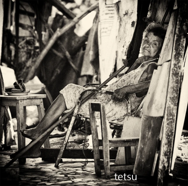 a woman sitting in a chair next to a building