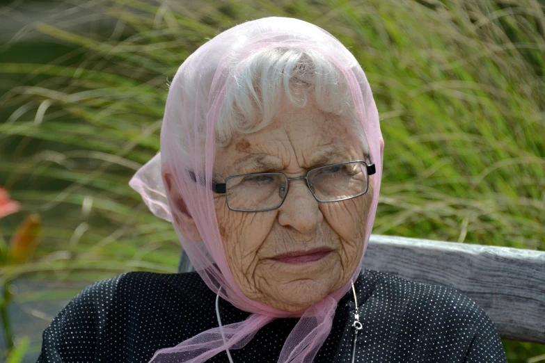 a woman with a pink bandanna on her head