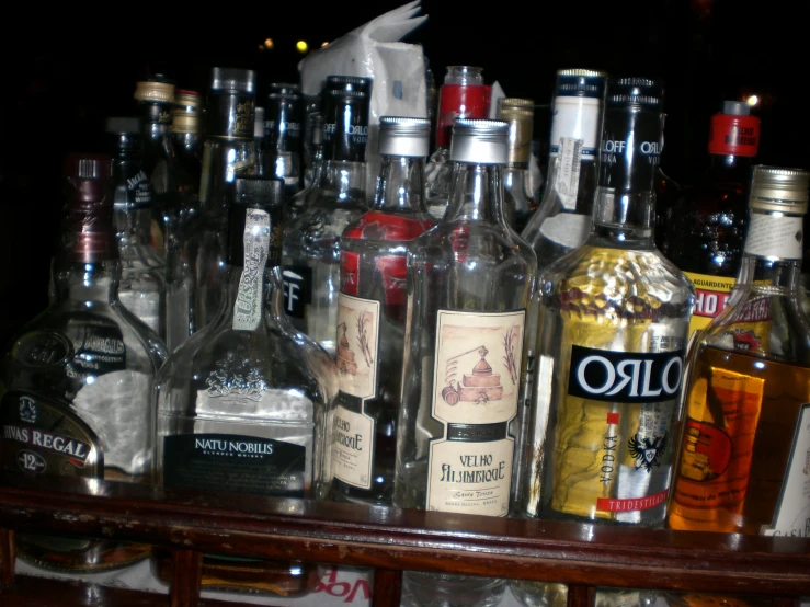 a close up of many bottles on a table