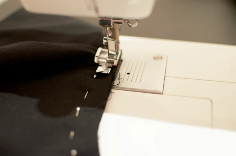 a close up of a sewing machine with a piece of fabric