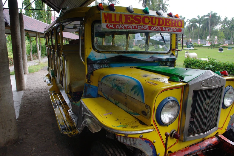 an old yellow school bus parked in a park