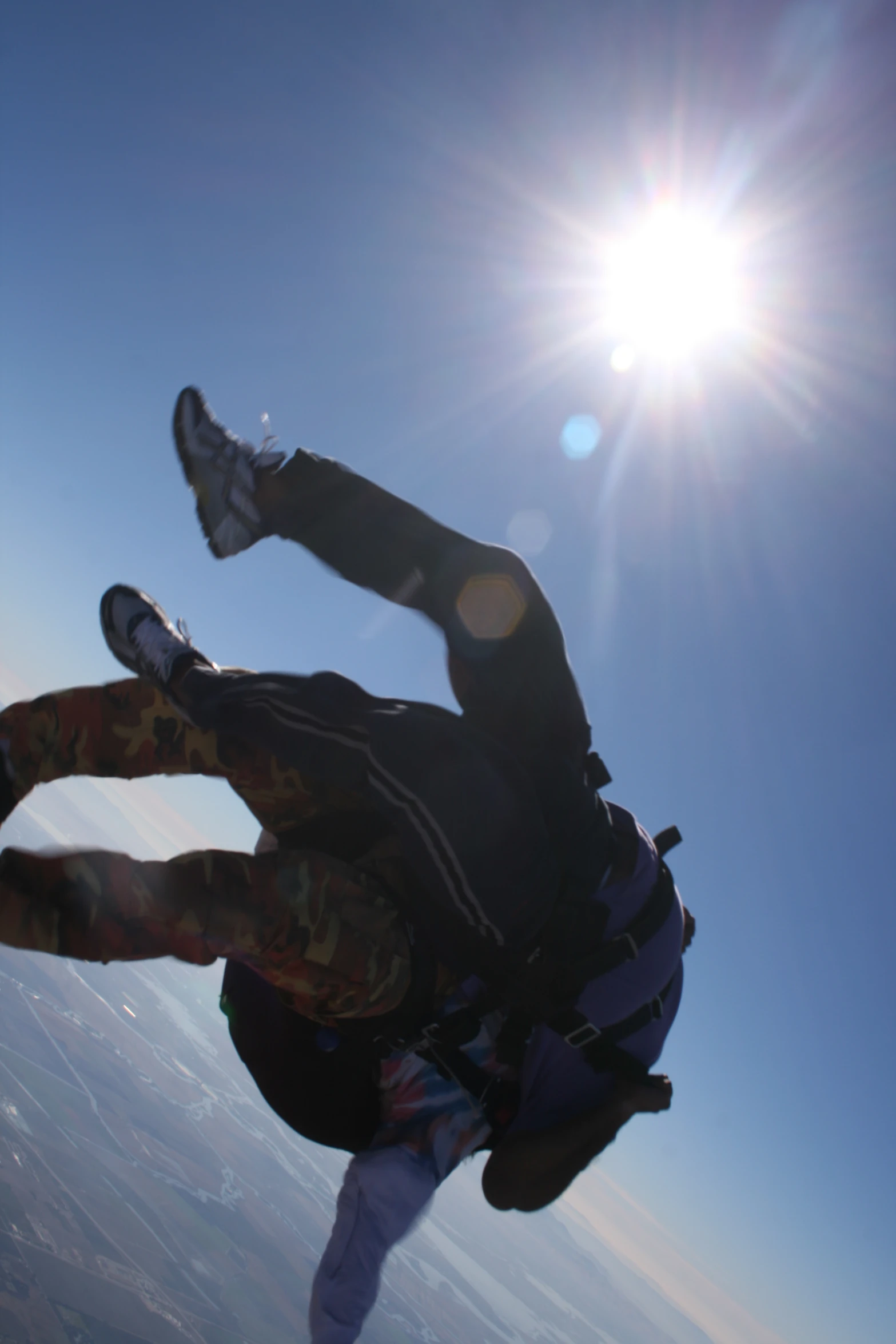 a man falling in the air as he hangs from a parachute