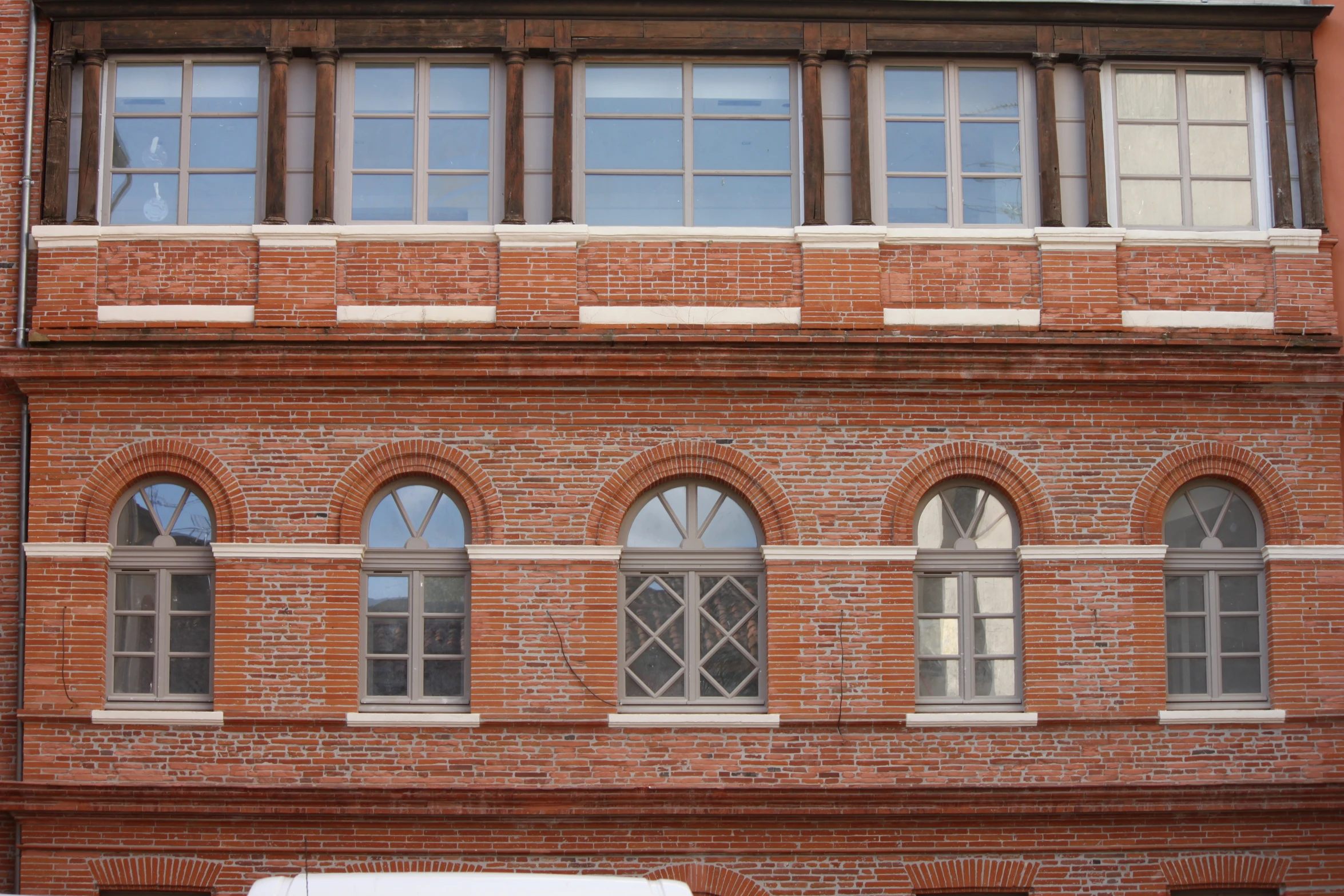 an old building made out of red bricks and has four arched windows