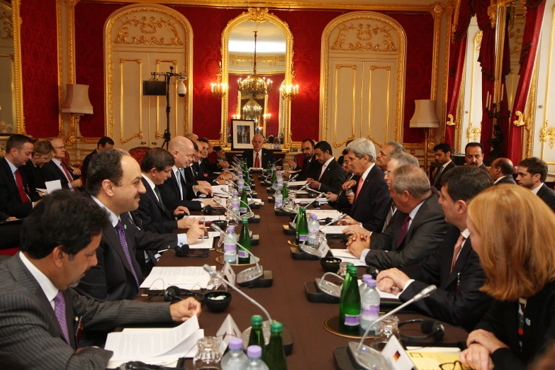 a meeting with a large group of people sitting at long tables