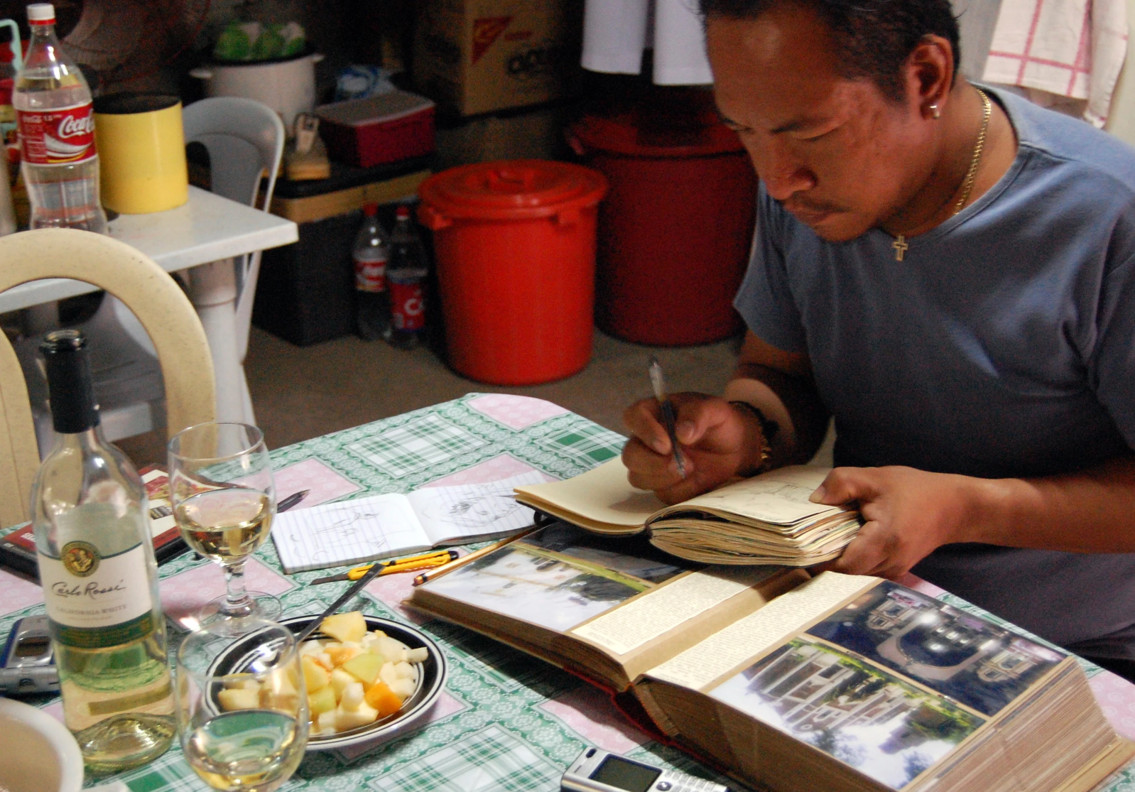 an image of a man in blue shirt taking notes