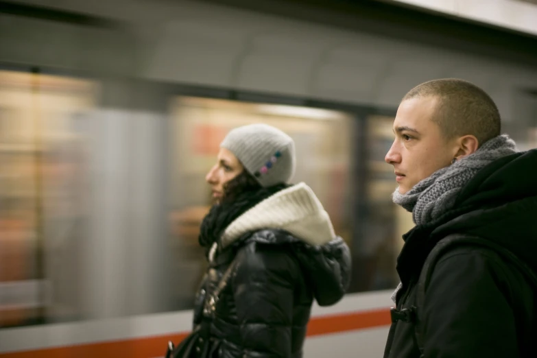 two people waiting for the subway in winter